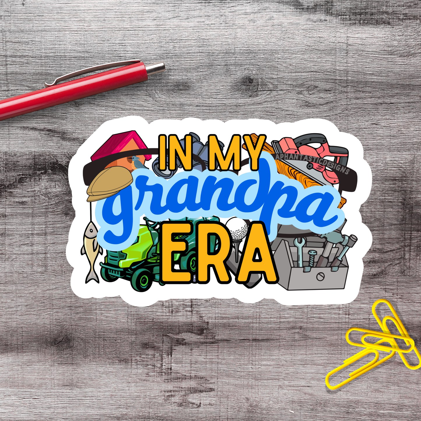 a sticker with the text "IN MY GRANDPA ERA" surrounded by various objects such as a pen, a stapler, and a pair of scissors.