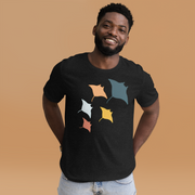 A smiling man wearing a black t-shirt with a graphic of colorful fish on it.