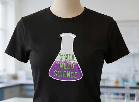 A mannequin wearing a black t-shirt with a graphic design of a laboratory flask and the text "Y'ALL NEED SCIENCE" printed on it.