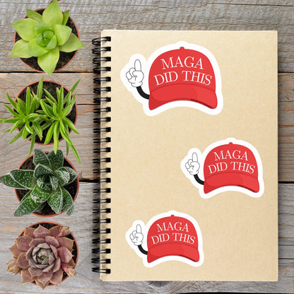 a spiral notebook with stickers on it, along with several potted plants arranged on a wooden surface.