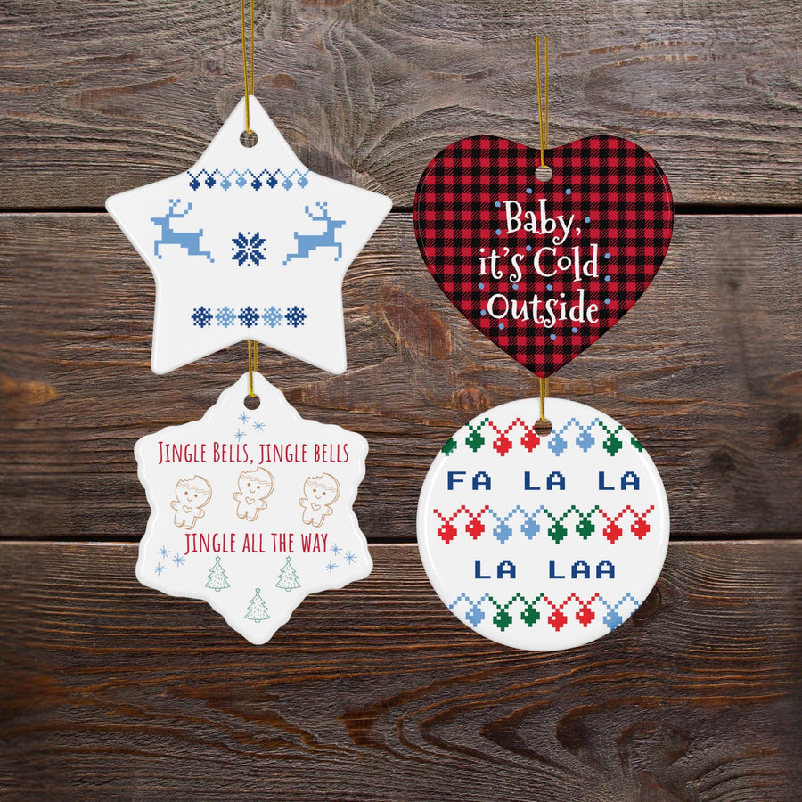 four ornaments hanging on a wooden surface, each with a unique design and text.