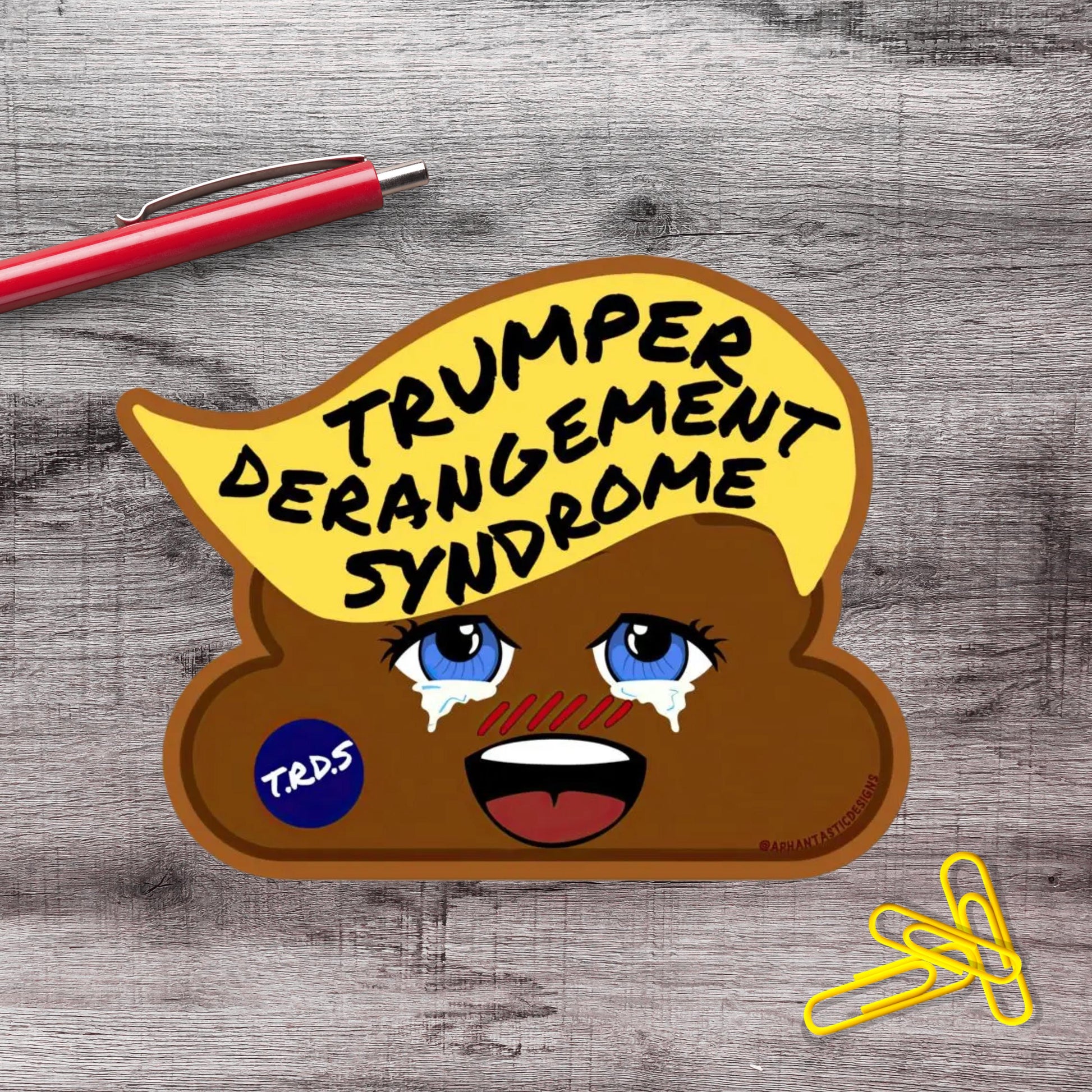 A sticker depicting a cartoon depiction of a brown, anthropomorphized toilet with a face and eyes, along with text that reads "Trump Derangement Syndrome" and a blue sticker with the letters "TRDS".