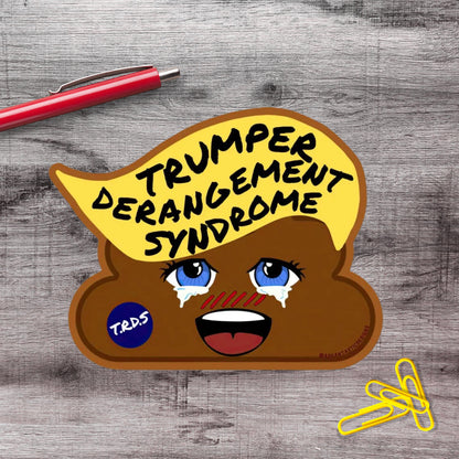 A sticker depicting a cartoon depiction of a brown, anthropomorphized toilet with a face and eyes, along with text that reads "Trump Derangement Syndrome" and a blue sticker with the letters "TRDS".