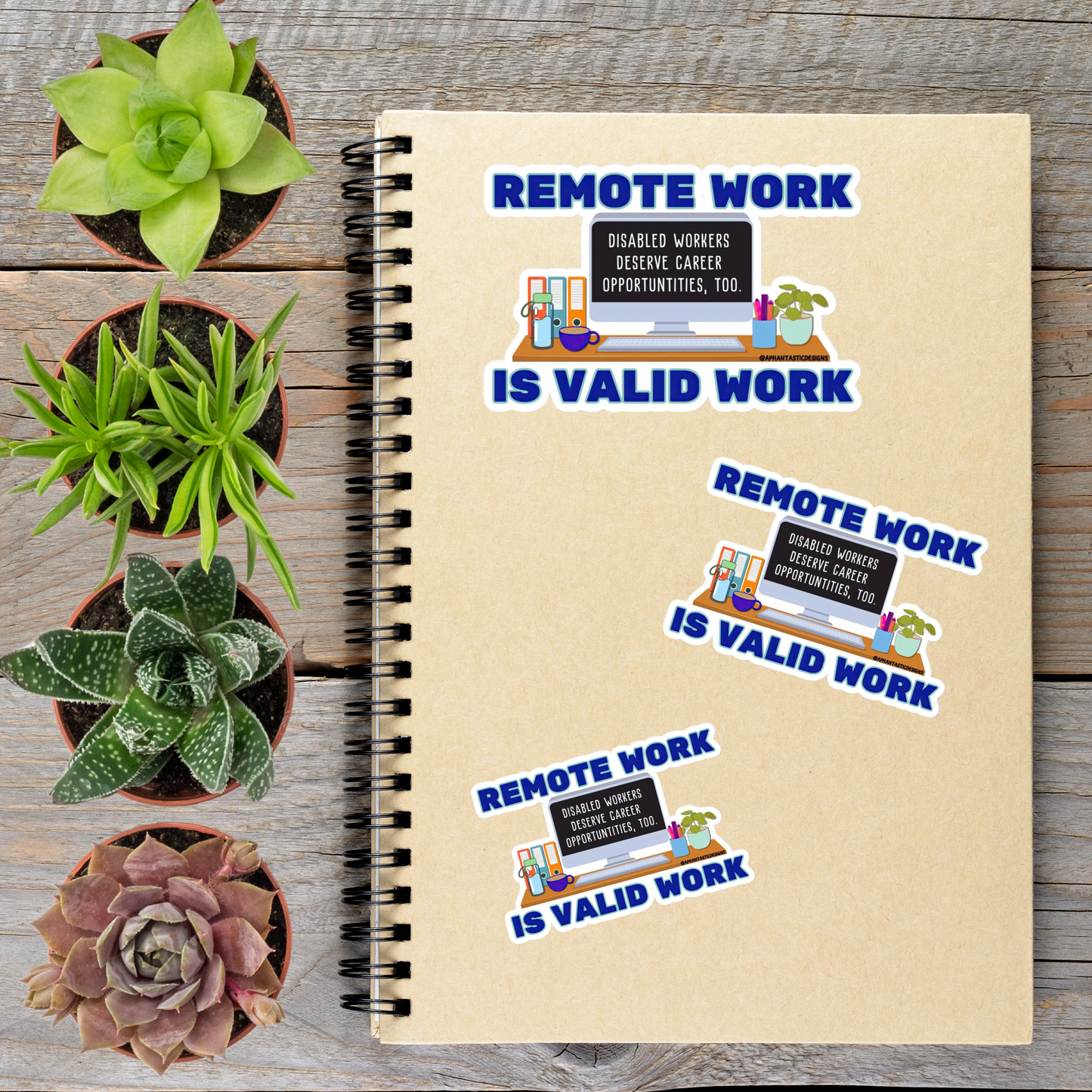 a notebook with stickers on it, along with several potted plants arranged on a wooden surface.