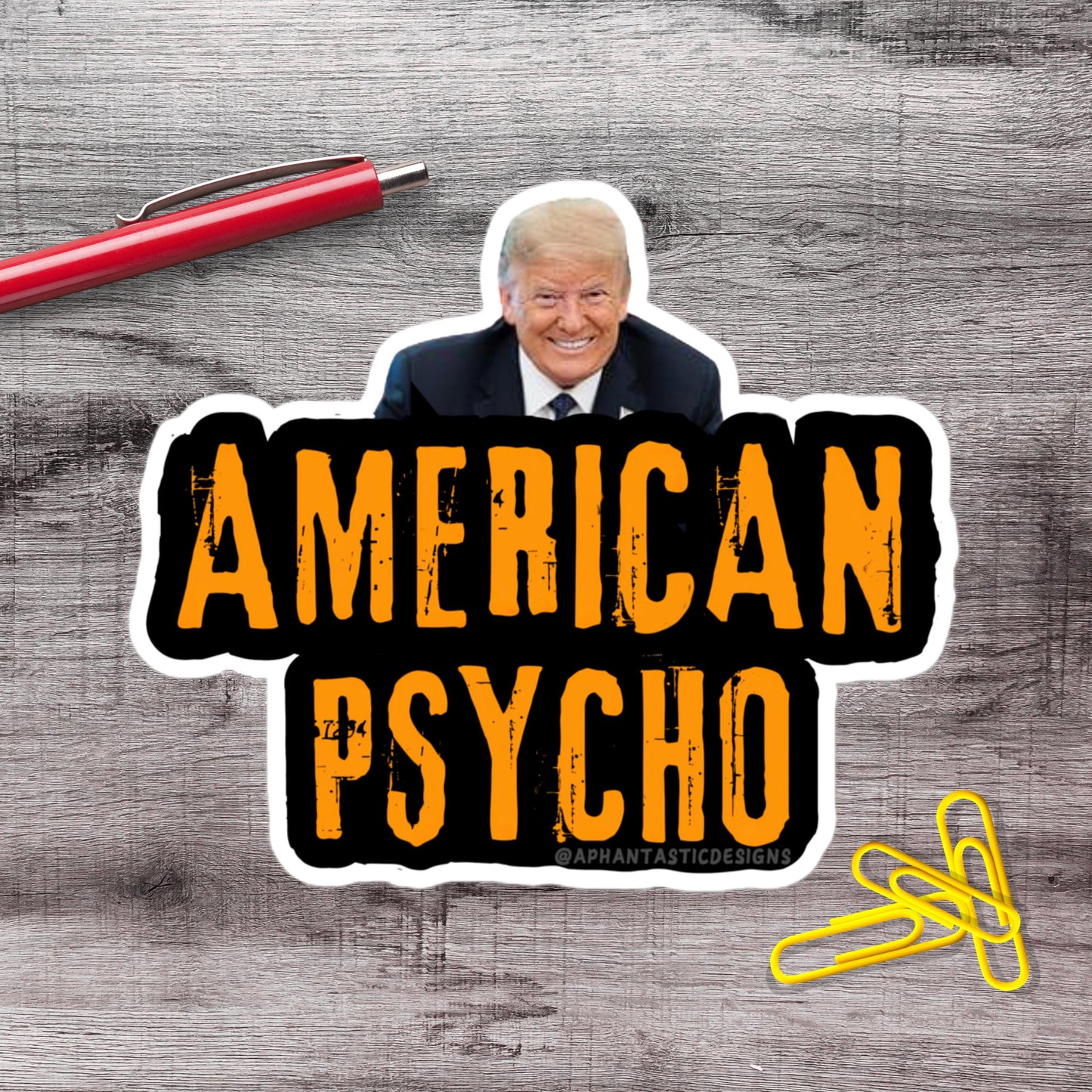 a sticker with a man's face and the text "AMERICAN PSYCHO" in bold, orange letters.