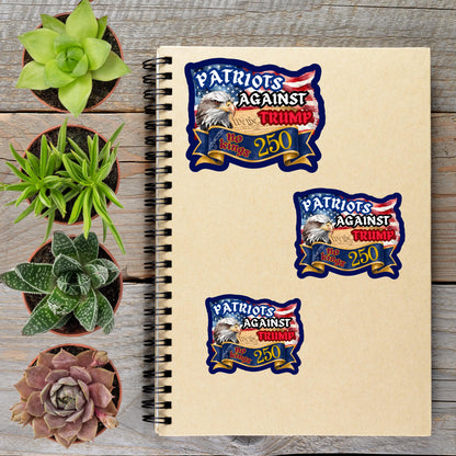 a spiral notebook with three stickers on it, along with several potted plants arranged on a wooden surface.