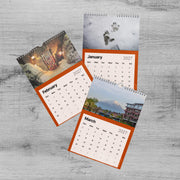 three calendar pages, each with different pictures and dates. The first page shows a snowy scene, the second page depicts a mountain, and the third page features a building.