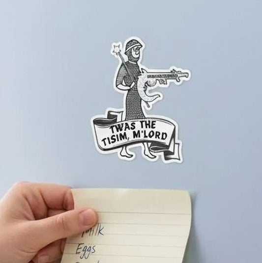 A hand is sticking a note on a refrigerator, which has a sticker of a cartoon character and text on it.