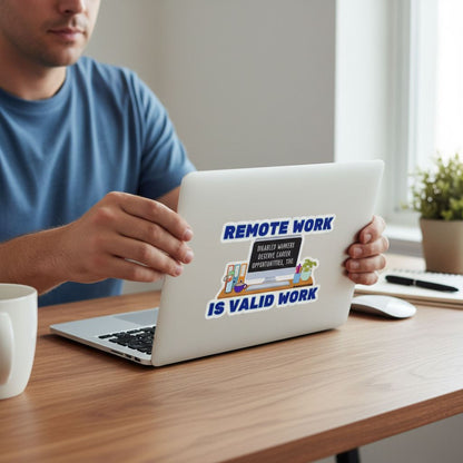 A person is sitting at a desk, holding a laptop with a sticker on it that says "REMOTE WORK IS VALID WORK".