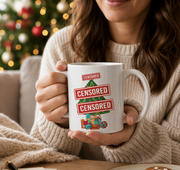A woman is sitting at a table with a mug of coffee, a plate of gingerbread cookies, and a pen, with a Christmas tree visible in the background.