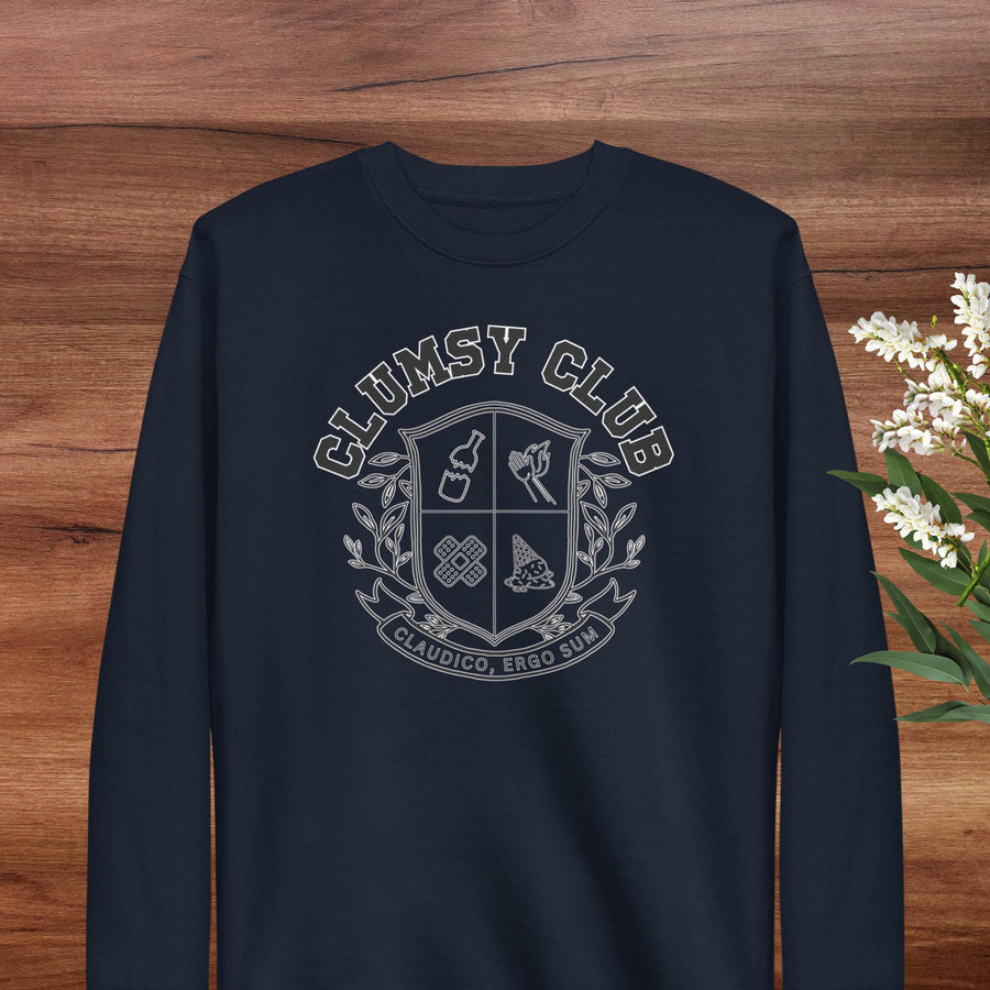 A navy blue long-sleeved shirt with a white graphic design on the front, featuring a shield-shaped emblem with various symbols and text.