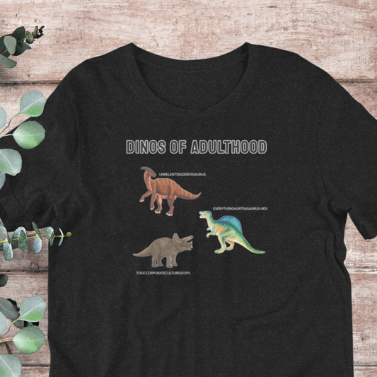 A black t-shirt with a graphic design depicting three different dinosaurs, including a triceratops, a brontosaurus, and a turocrocrocrocoros, along with the text "DINOS OF ADULTHOOD" and "Everything's better with the Rex".