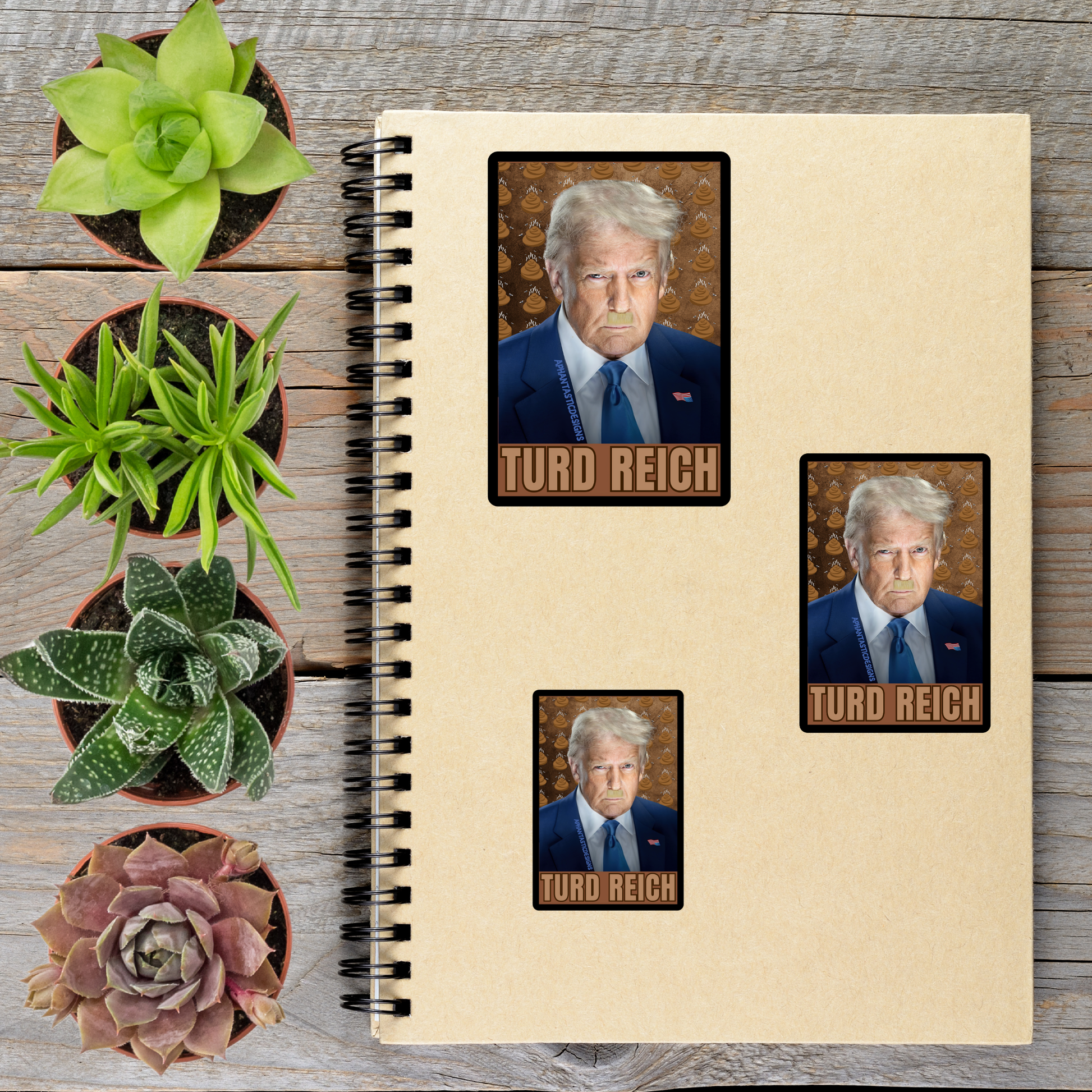 a spiral notebook with three stickers on it, each depicting a man wearing a suit and tie. The stickers are arranged on the notebook, and there are several potted plants placed around the notebook and stickers.
