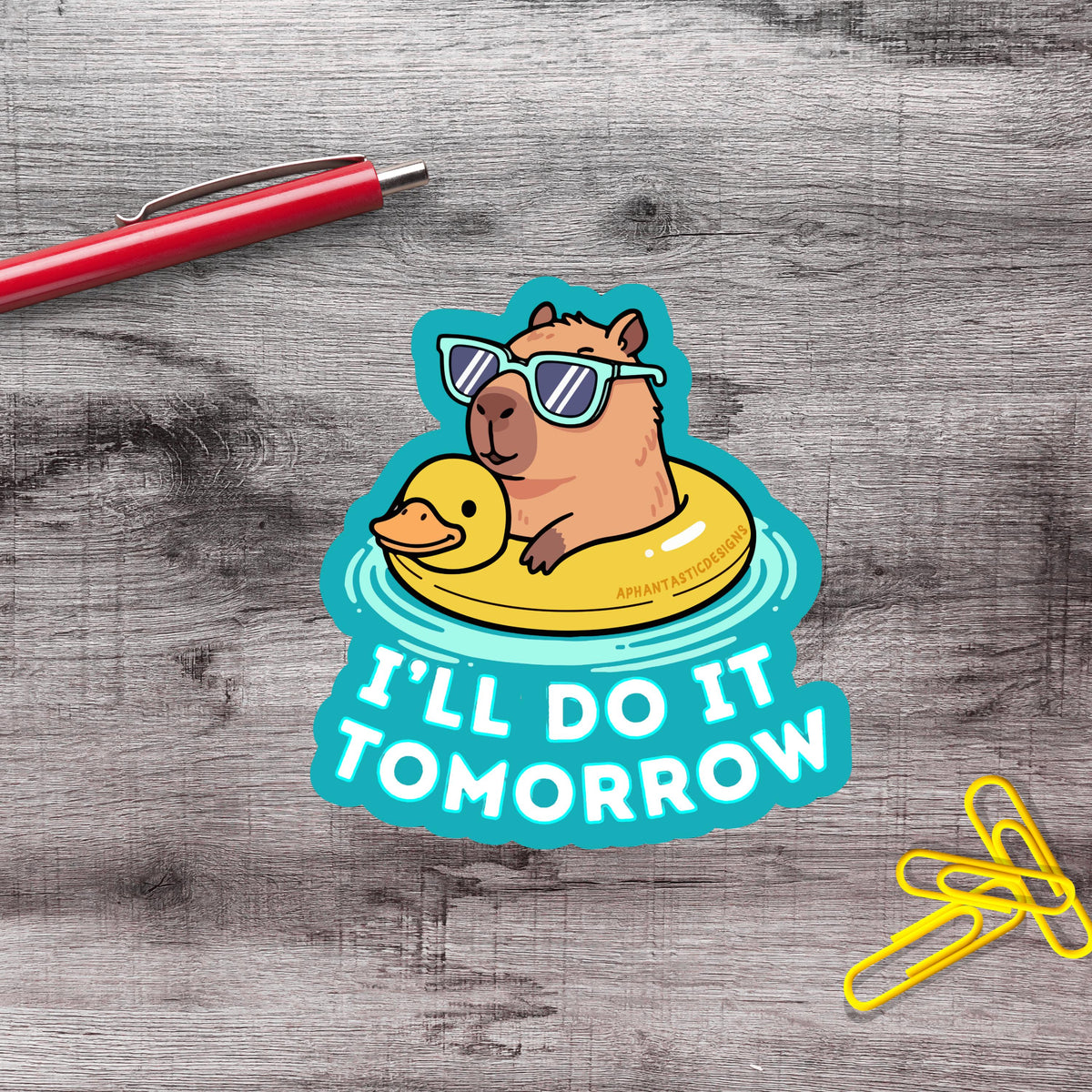 A sticker with a cartoon image of a duck wearing sunglasses and floating on an inflatable ring, along with the text "I'll do it tomorrow".