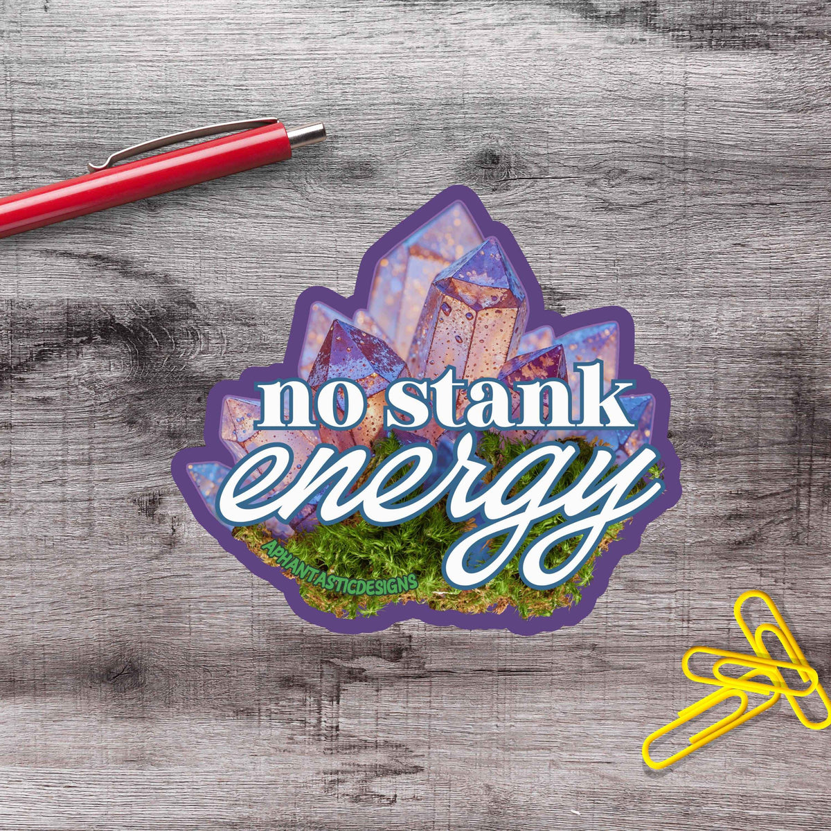 a sticker with the text "no stink energy" and an illustration of a crystal or gemstone.