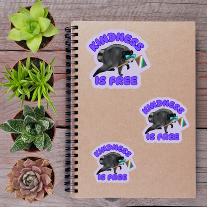 a notebook with stickers on it, surrounded by potted plants and a wooden surface.