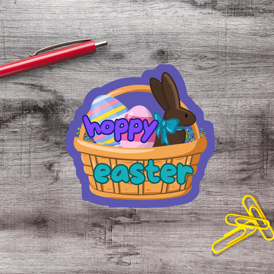 A sticker with a basket containing Easter eggs and a brown bunny, along with the text "hopey easter" written on it.