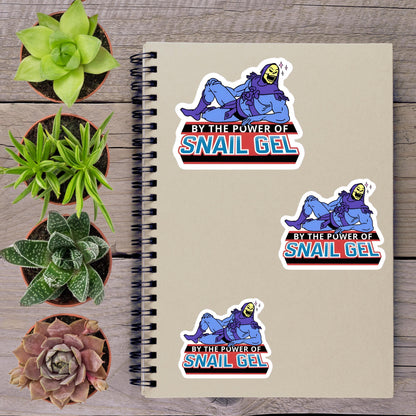 a spiral notebook with stickers on it, along with several potted plants arranged on a wooden surface.