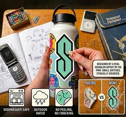 a person's hands holding a water bottle with a sticker on it, surrounded by various objects such as a cell phone, a notebook, and other items.