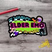 a sticker with a bold, colorful design and text that reads "IT WASN'T ELDER EMO A PHASE".