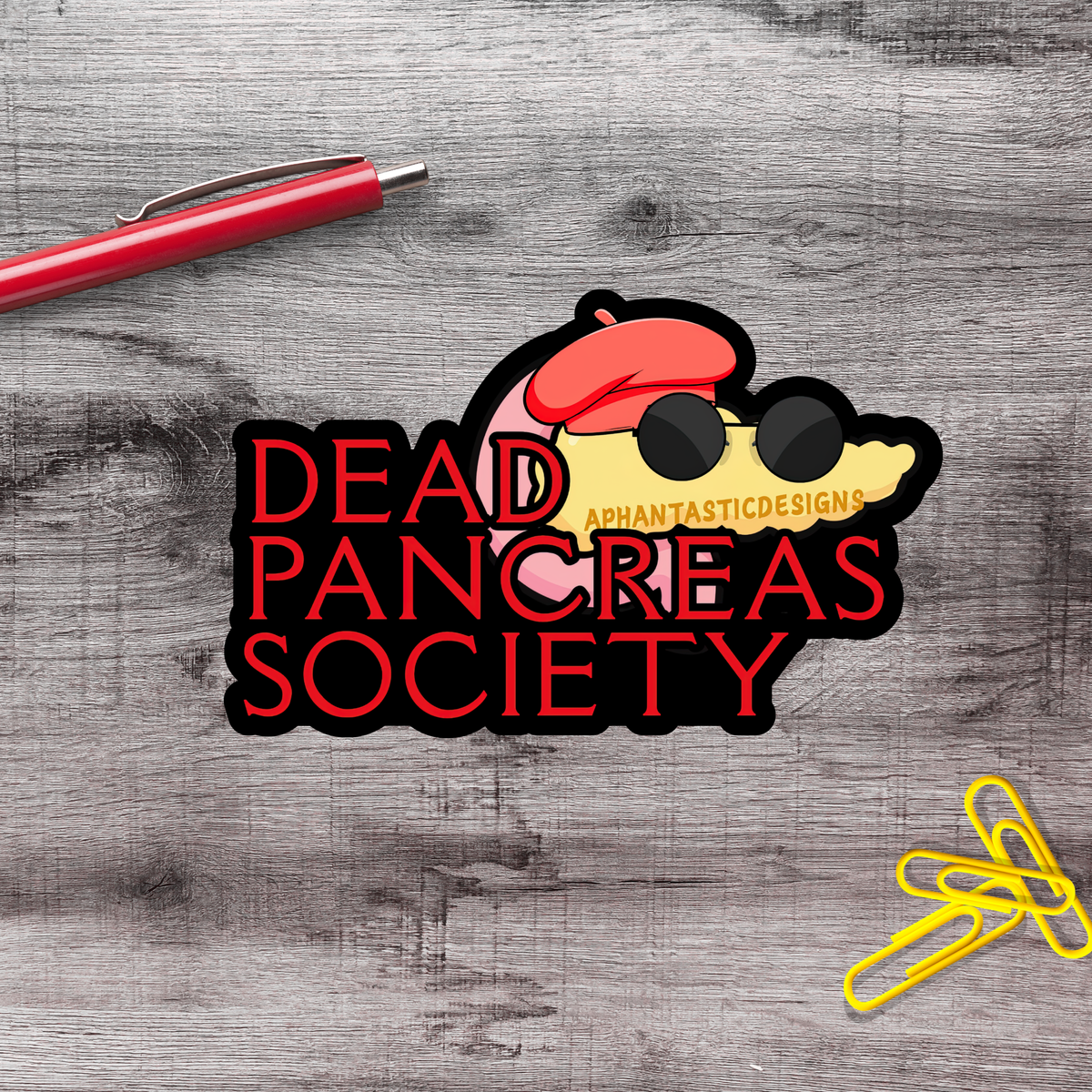 a sticker with the text "Dead Pancreas Society" and a cartoon character wearing a red hat and sunglasses.