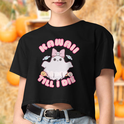 A person wearing a black crop top with a graphic design featuring a ghost character and the text "KAWaii Till I Die".