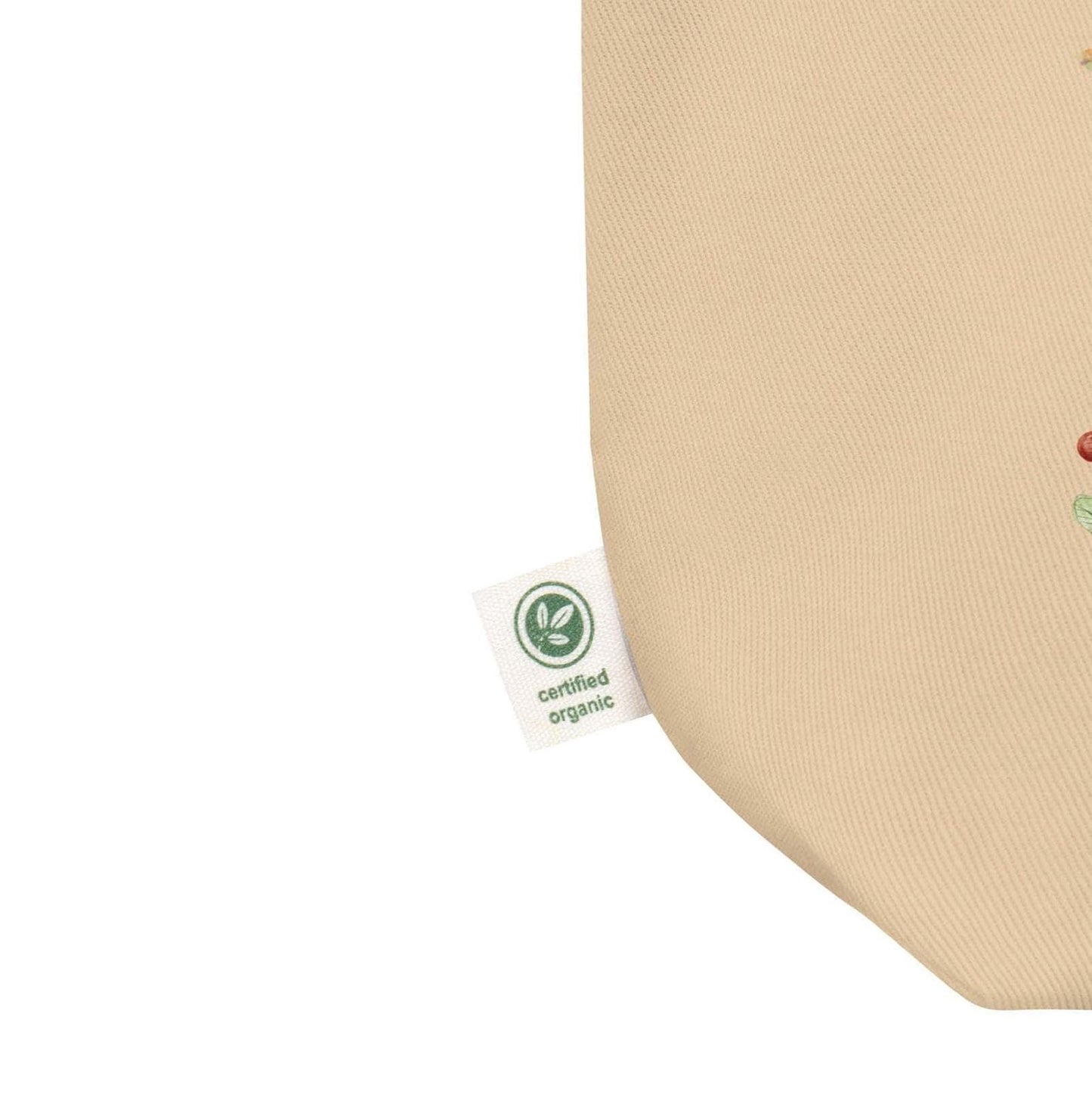 a beige fabric with a green "certified organic" label attached to it, indicating that the fabric is made from organic materials.