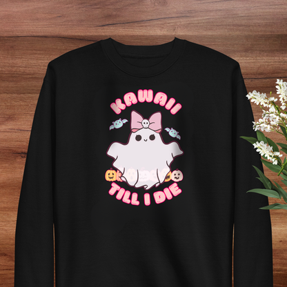 A black sweatshirt with a graphic design featuring a ghost character with a bow and the text "KAWAII! TILL I DIE" printed on it.