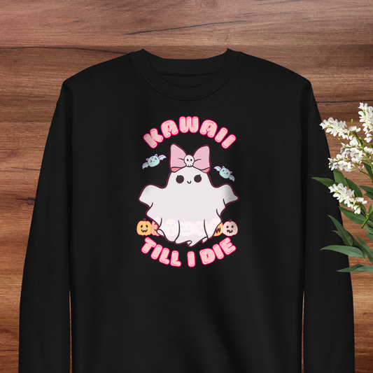 A black sweatshirt with a graphic design featuring a ghost character with a bow and the text "KAWAII! TILL I DIE" printed on it.