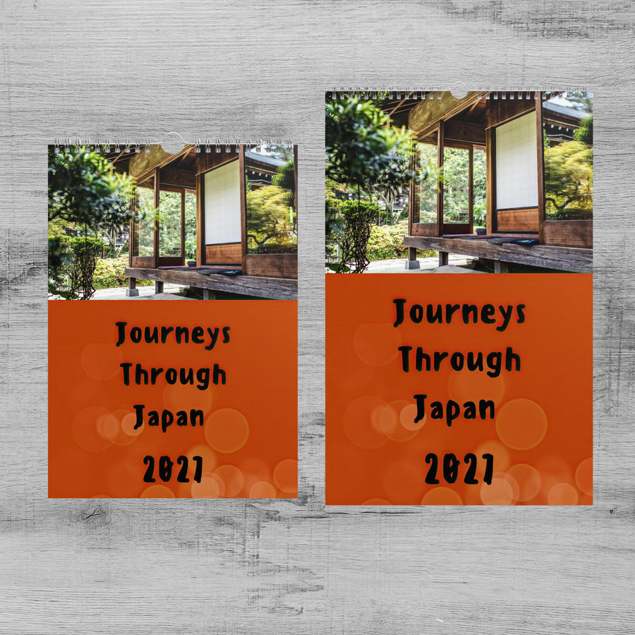 The image is a calendar featuring a photograph of a traditional Japanese building surrounded by trees. The calendar is divided into two sections, with the left section displaying the text "Journeys Through Japan" and the right section displaying the text "Journeys Through Japan" and the date "2821".