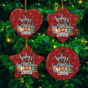 four red Christmas ornaments hanging on a tree, each with the text "baby's first christmas 2026" printed on them.