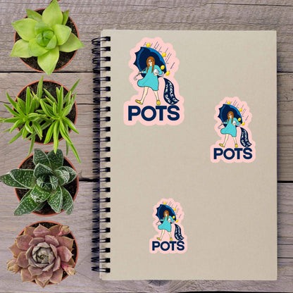 a spiral notebook with stickers on it, surrounded by various potted plants.