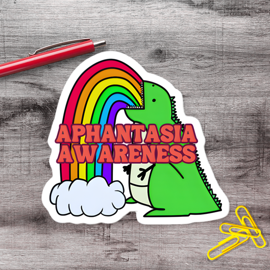 A sticker with a green dinosaur and a rainbow, along with the text "Aphantasia AWARENESS" written on it.