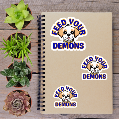 a notebook with stickers on it, surrounded by potted plants and a wooden surface.