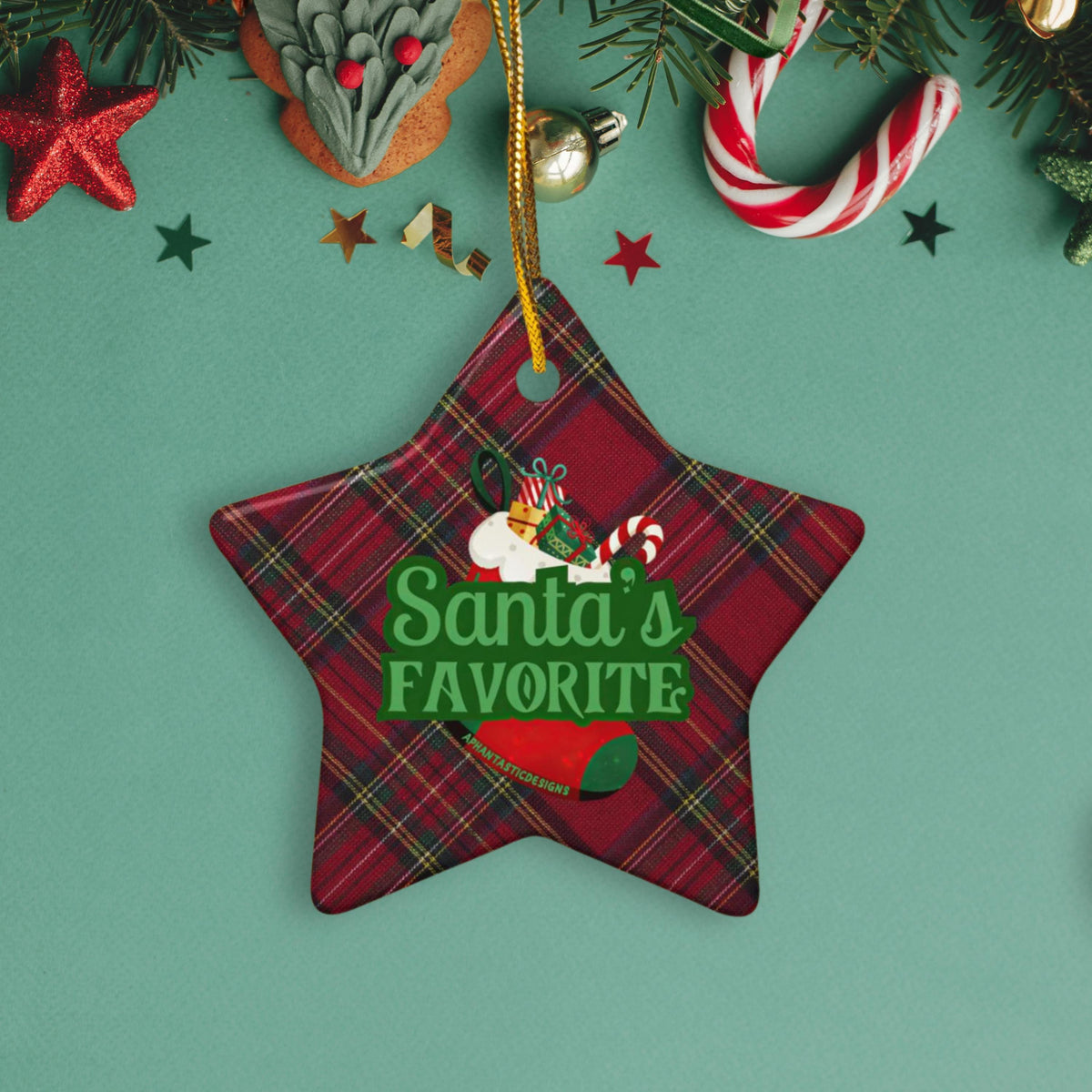 A Christmas ornament with a plaid pattern and the text "Santa's FAVORITE" is displayed on a green background.