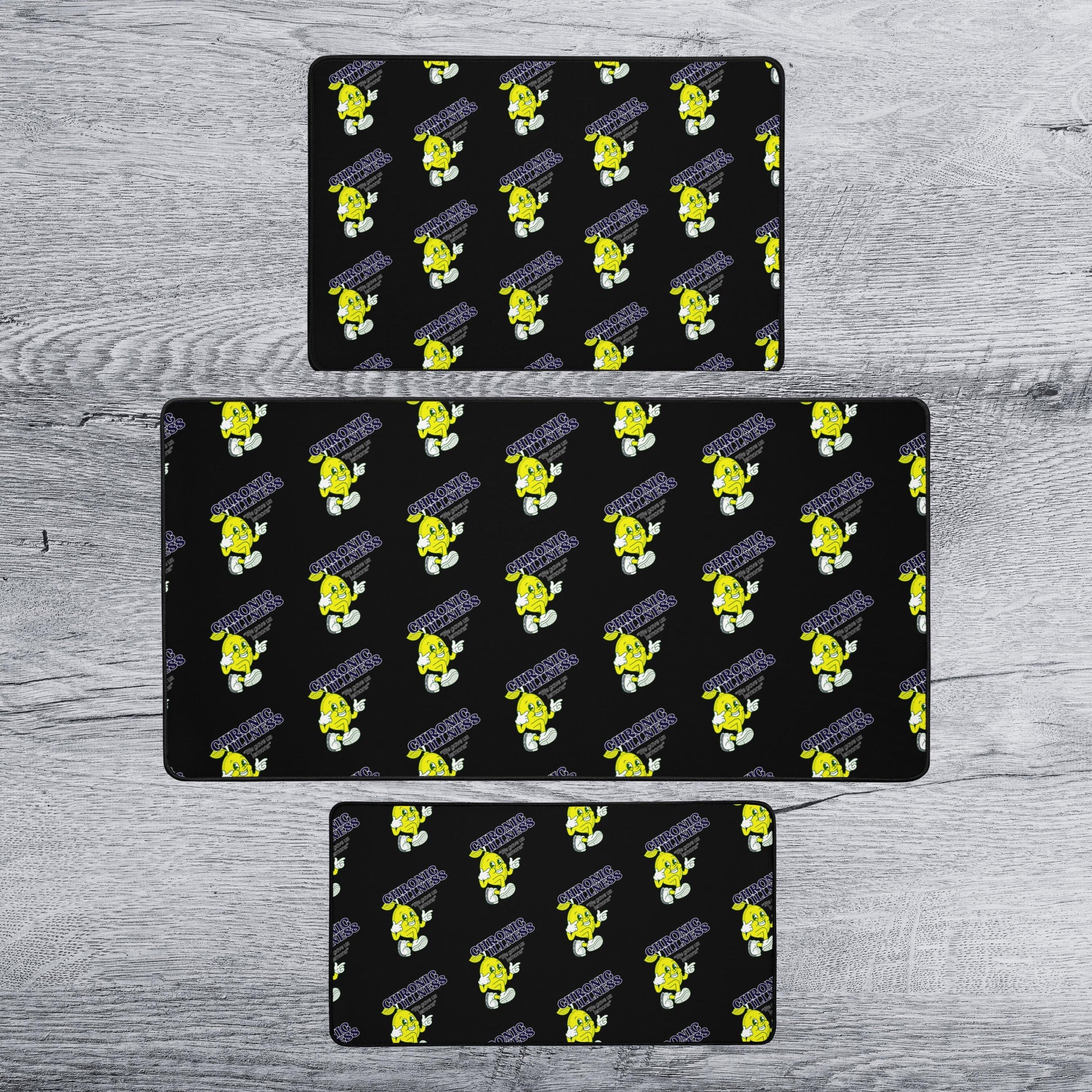three identical black rectangular mats with a repeating yellow cartoon character pattern on them.