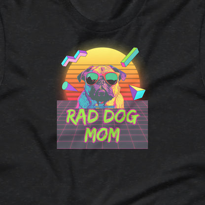 A graphic design on a black t-shirt featuring a pug dog wearing sunglasses, with a retro-style sun and geometric shapes in the background.