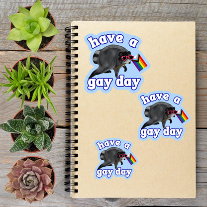 a spiral notebook with stickers on it, along with several potted plants arranged on a wooden surface.