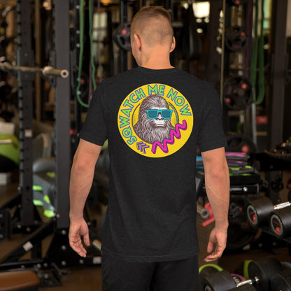A man wearing a black t-shirt with a colorful graphic design on the back, including a large skull wearing sunglasses and the text "ME NOW" in a circular pattern.