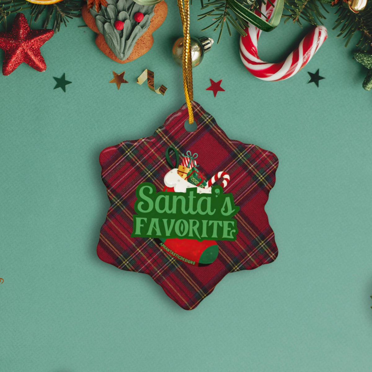 A Christmas ornament with a plaid pattern and the text "Santa's Favorite" is displayed on a green background.
