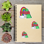 a spiral notebook with stickers on it, surrounded by potted plants on a wooden surface.