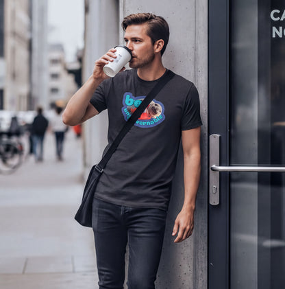 A man is standing on a sidewalk, drinking from a cup and leaning against a building.