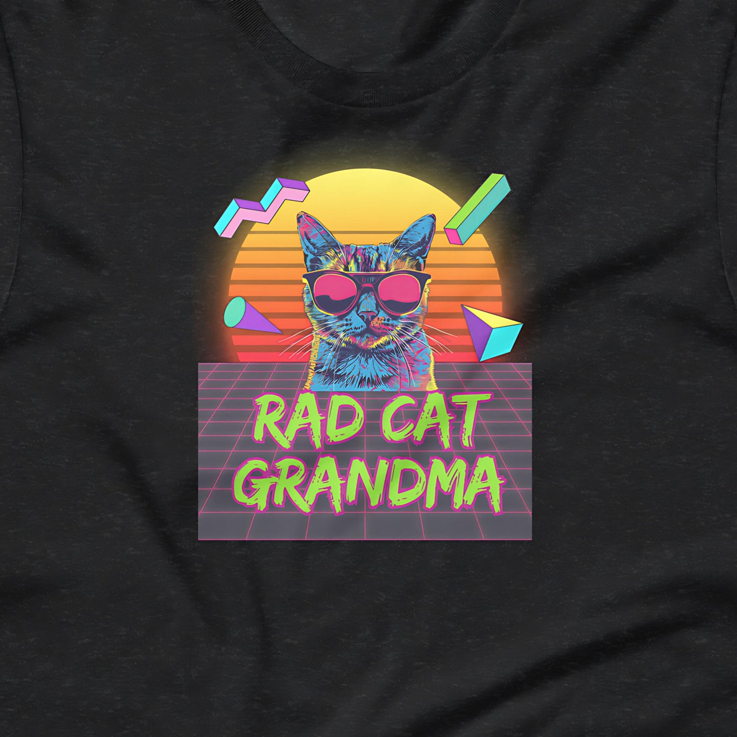 A graphic design featuring a cat wearing sunglasses, with a neon sunset and geometric shapes in the background. The text "RAD CAT GRANDMA" is displayed below the cat.