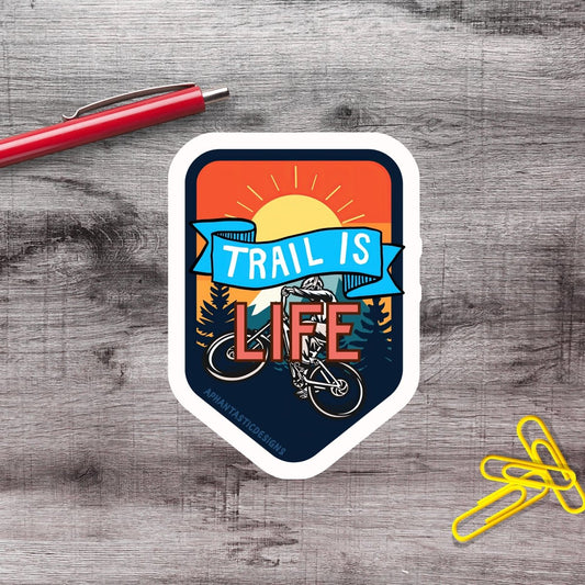 a sticker with the phrase "Trail is life" and an illustration of a person riding a bicycle.