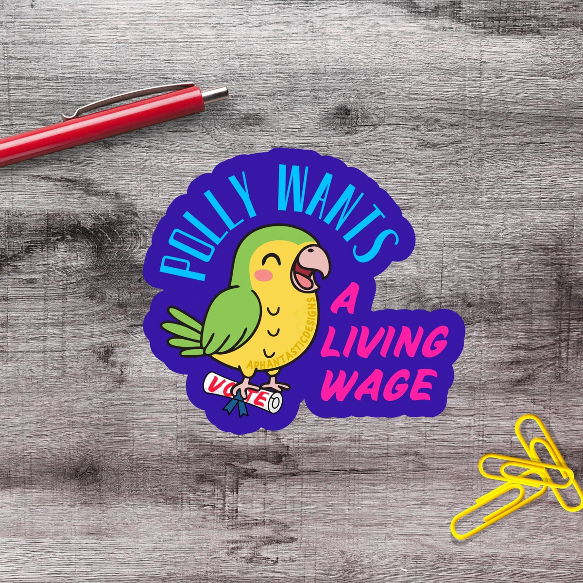 a sticker with a cartoon parrot and the text "Polly Wants a Living Wage" on a wooden surface.