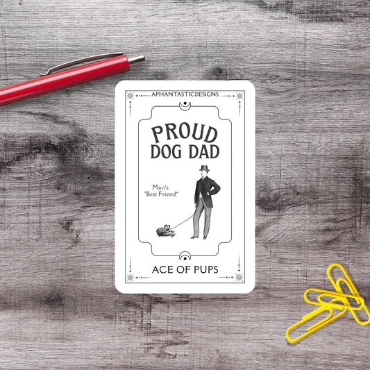 a card with a drawing of a man walking a dog, placed on a wooden surface next to a red pen and yellow paper clips.