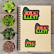 a spiral notebook with three stickers on it, along with four potted succulent plants arranged on a wooden surface.