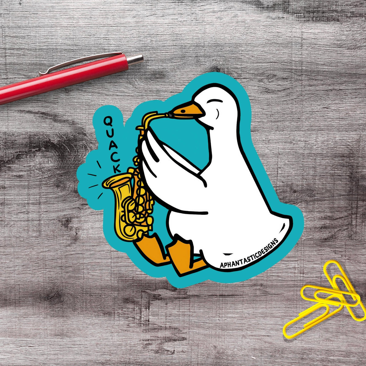 A sticker depicting a cartoon duck playing a saxophone, with the word "quack" written above it.